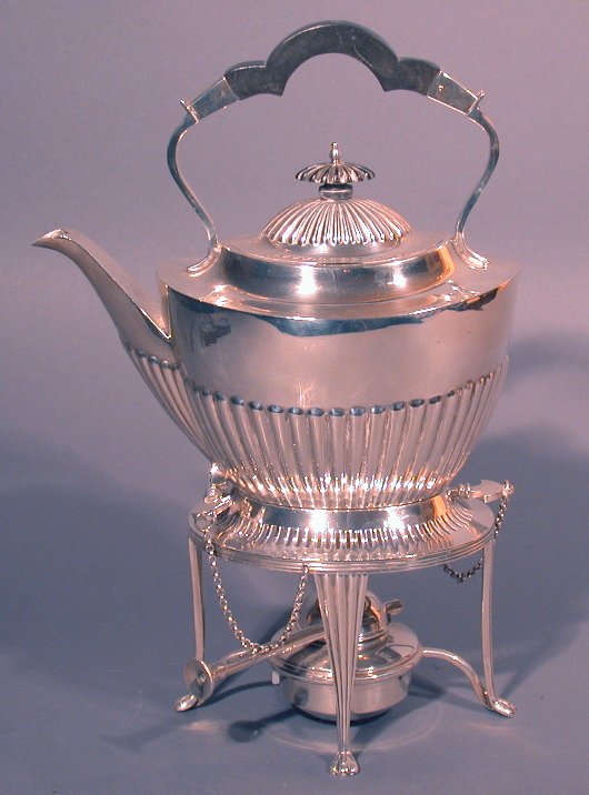 A silver kettle-on-stand