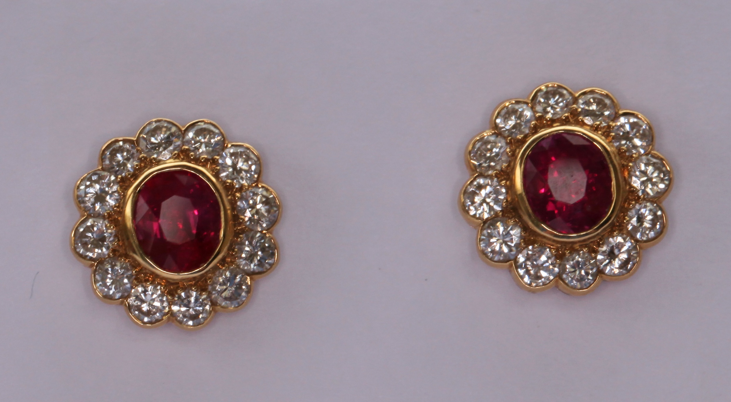 An attractive pair of Burmese ruby and diamond ear studs