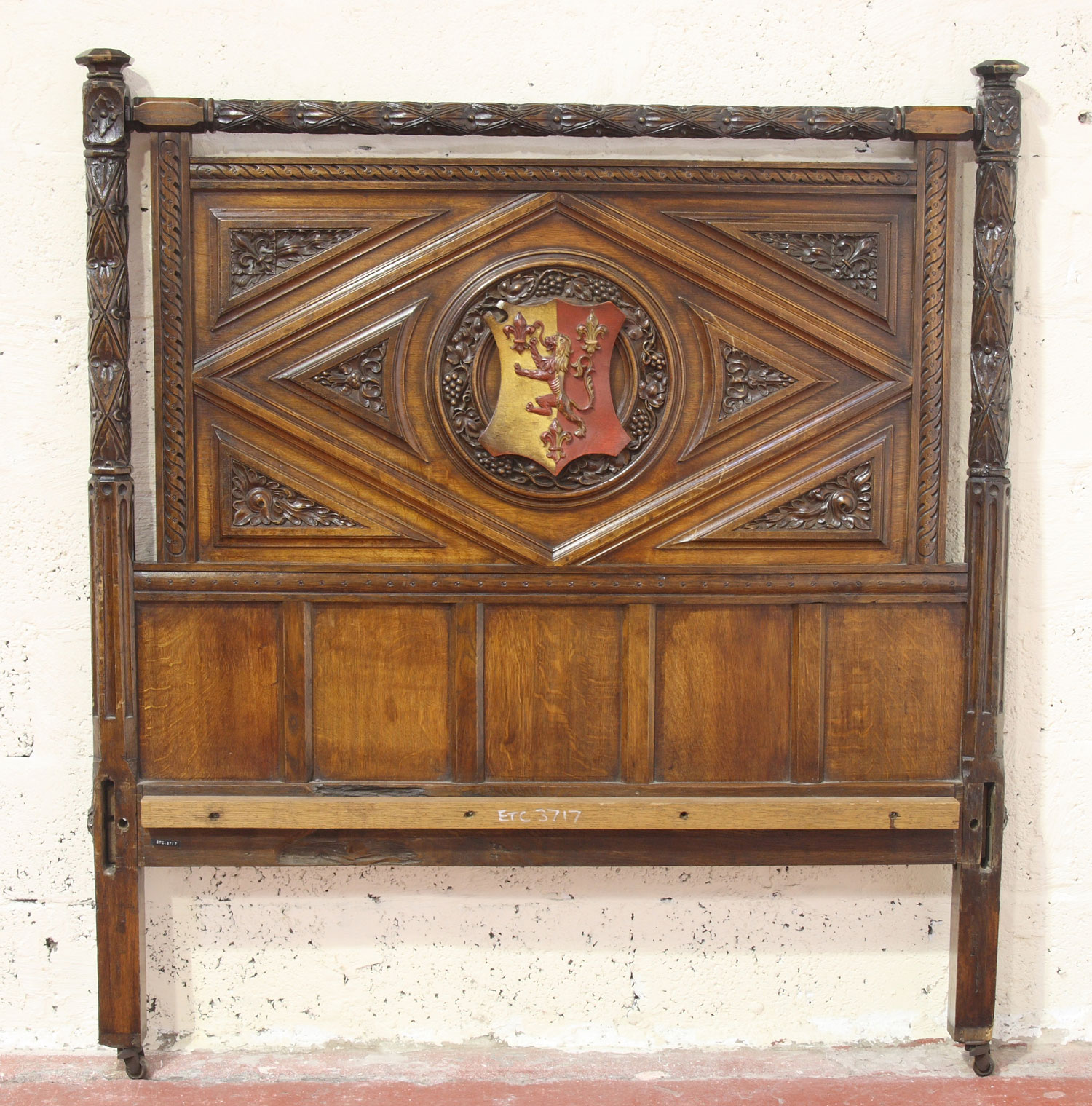 A Victorian carved oak and panelled double bed, in the Elizabethan manner