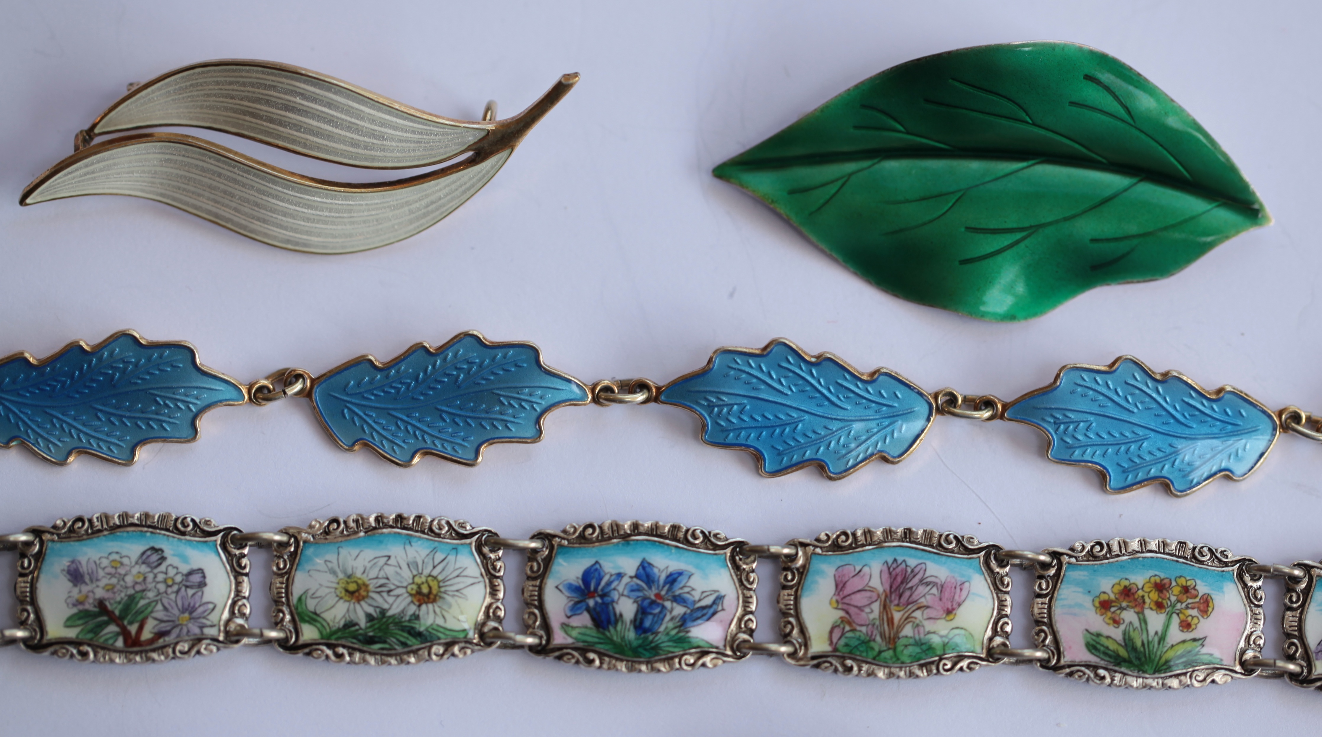 A collection of enamel jewellery