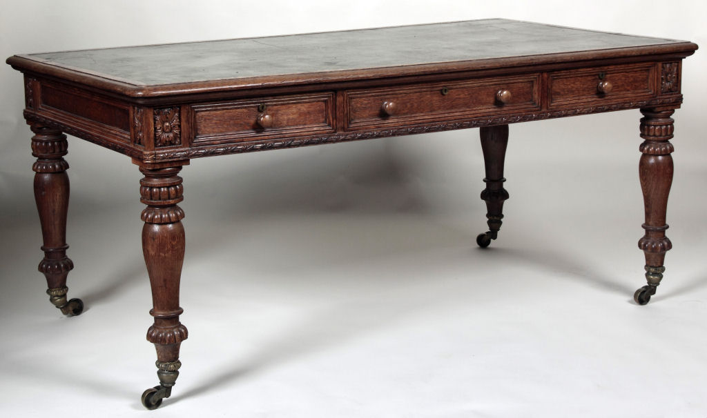 A late Victorian ornate carved oak library table