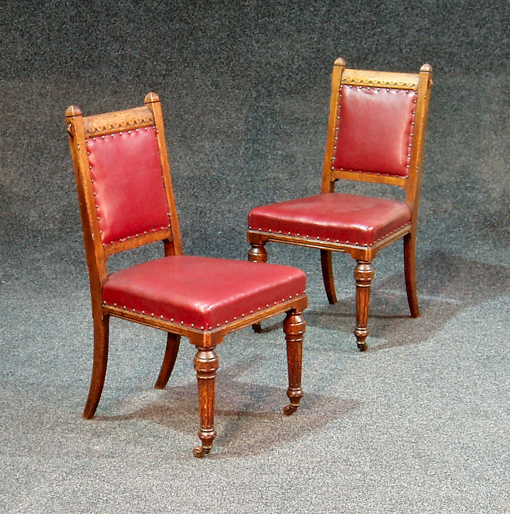 A set of ten oak Gothic style dining chairs by John Taylor and son, Edinburgh " R810"