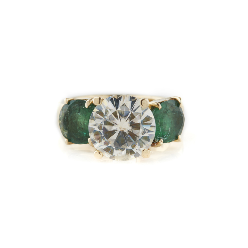An emerald and imitation diamond set ring
