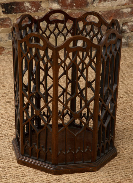 A stained beech waste paper bin