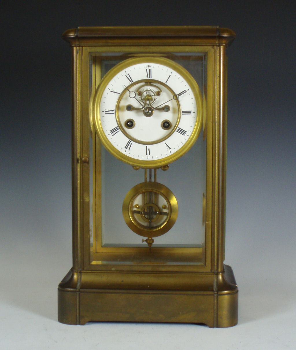 A French four glass brass cased mantel clock