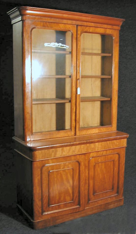 A mahogany bookcase on cabinet,