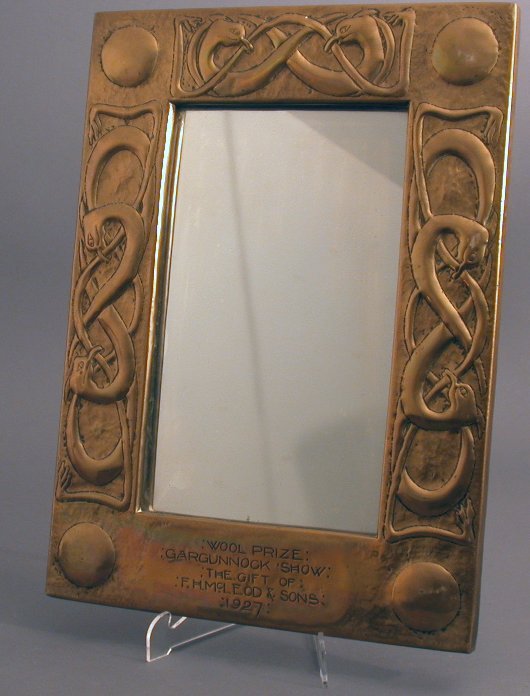 A Scottish School brass wall mirror