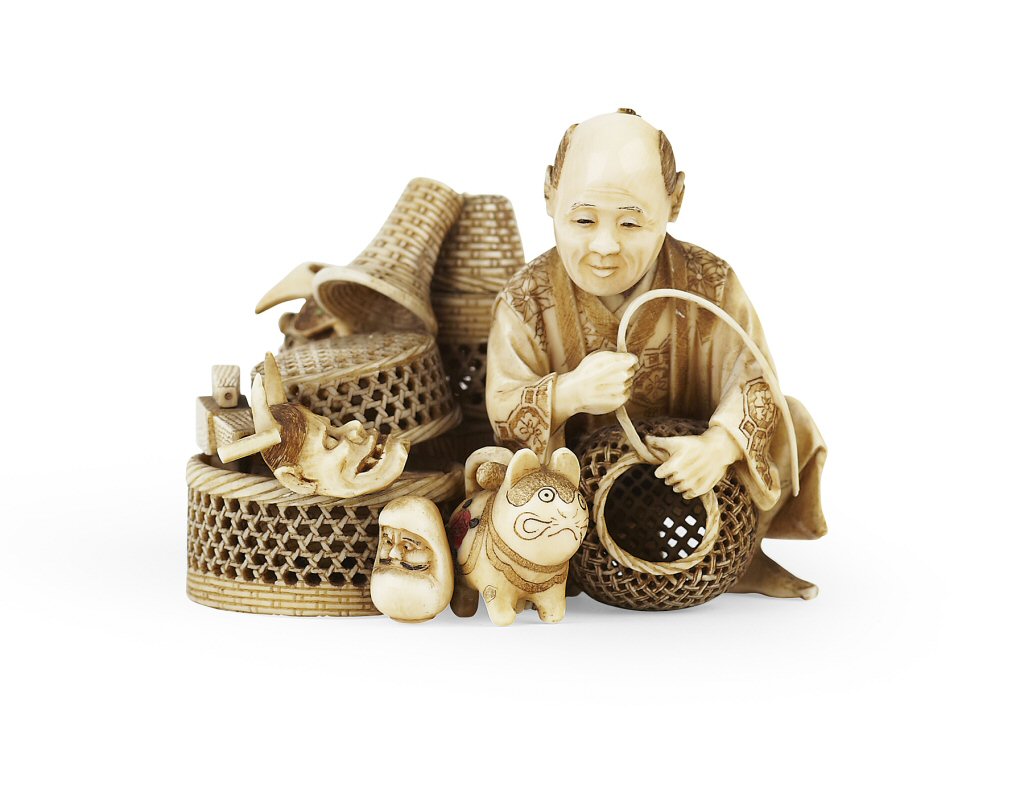 JAPANESE IVORY OKIMONO OF A BASKET SELLER