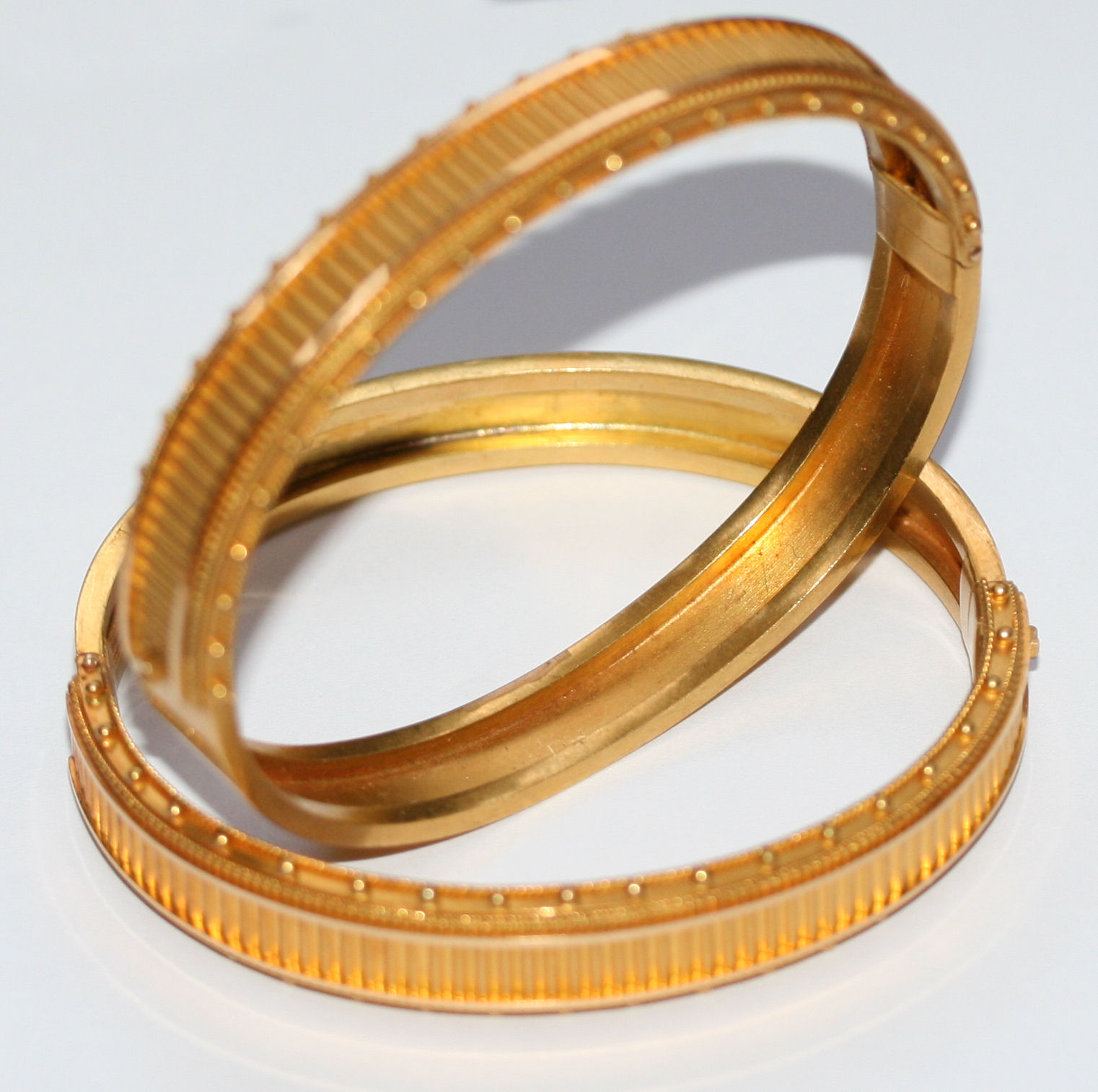A pair of Victorian hinged gold bangles