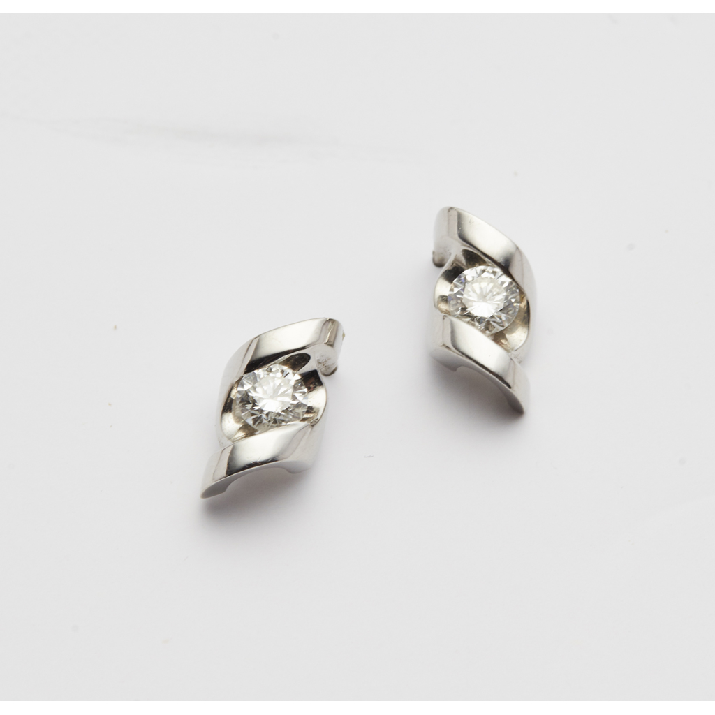 A pair of platinum and diamond set earrings