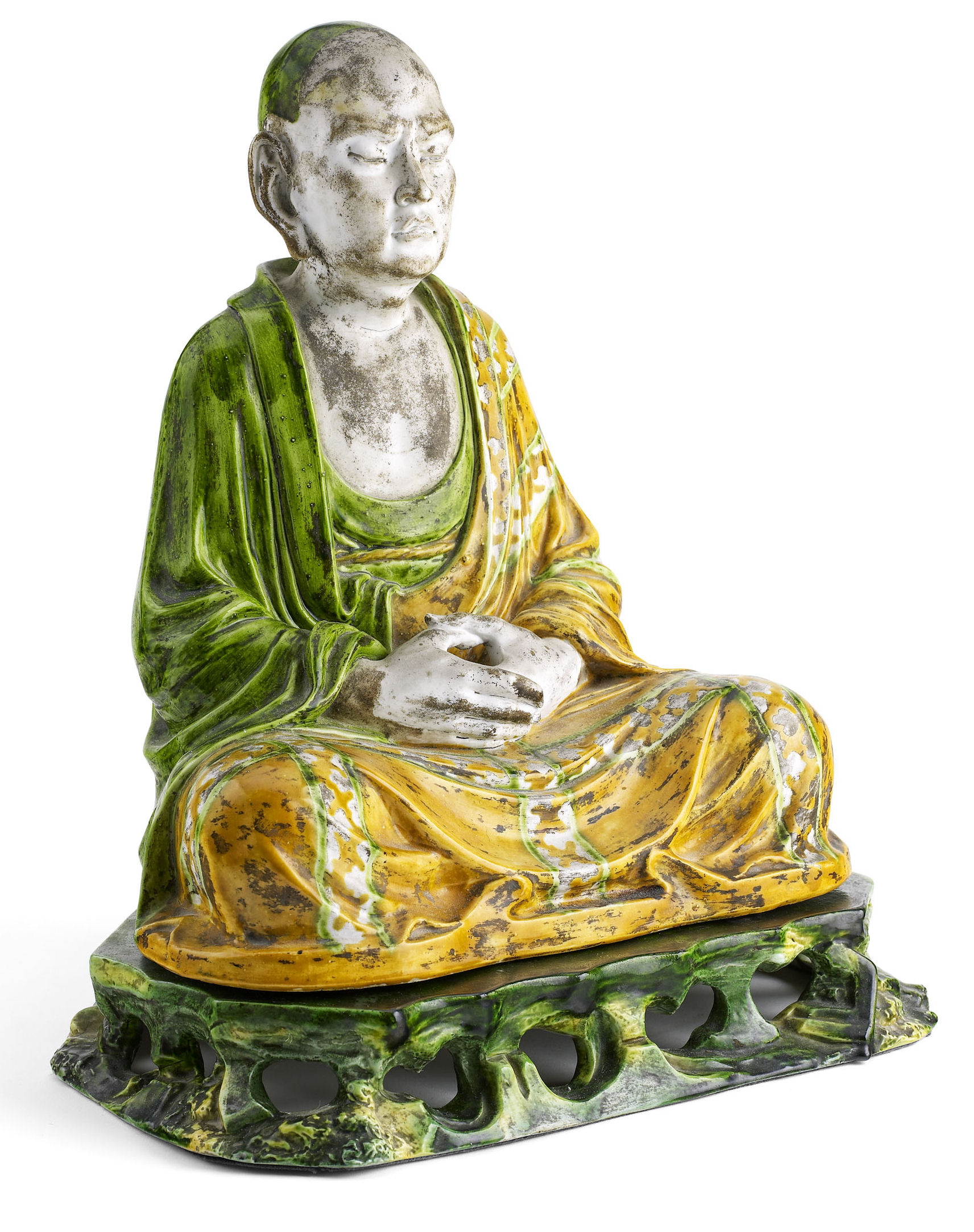 A Chinese pottery figure of a lohan In the Liao Dynasty style