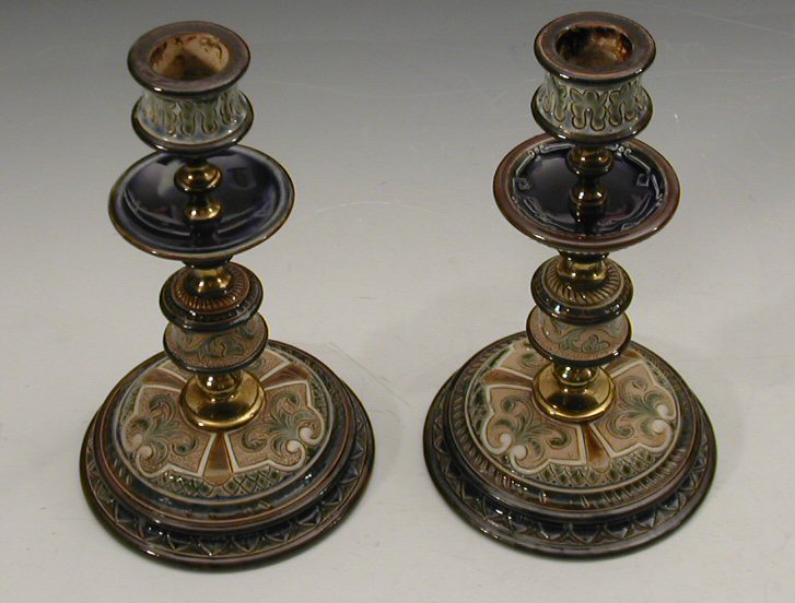 A matched pair of Doulton Lambeth candlesticks decorated by Frank Butler