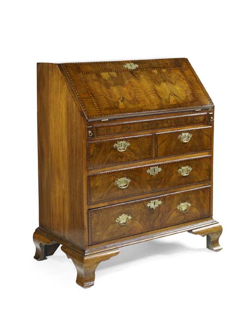 An early 18th century walnut and chevron banded bureau