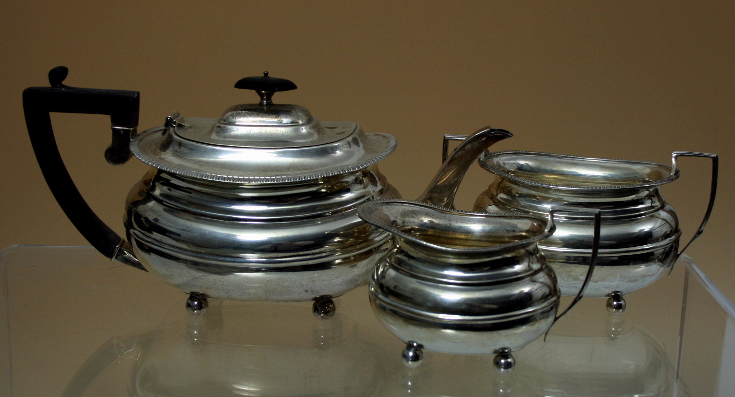 A silver three piece tea service