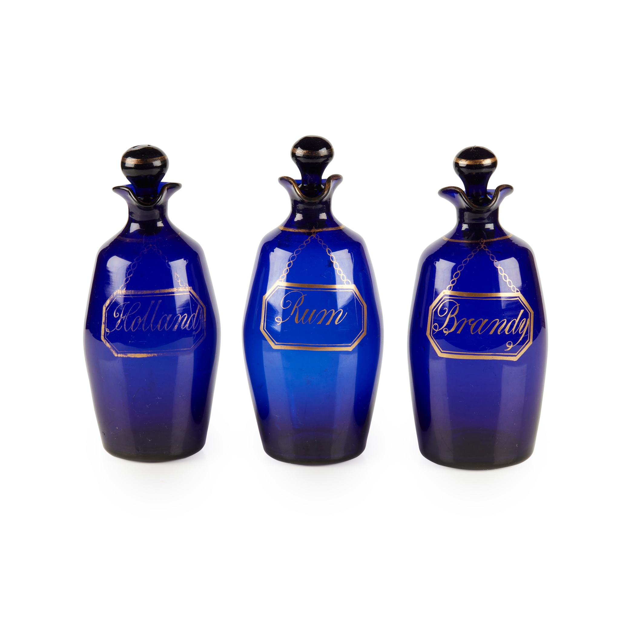 A SET OF THREE BRISTOL BLUE GLASS DECANTERS AND STOPPERS
