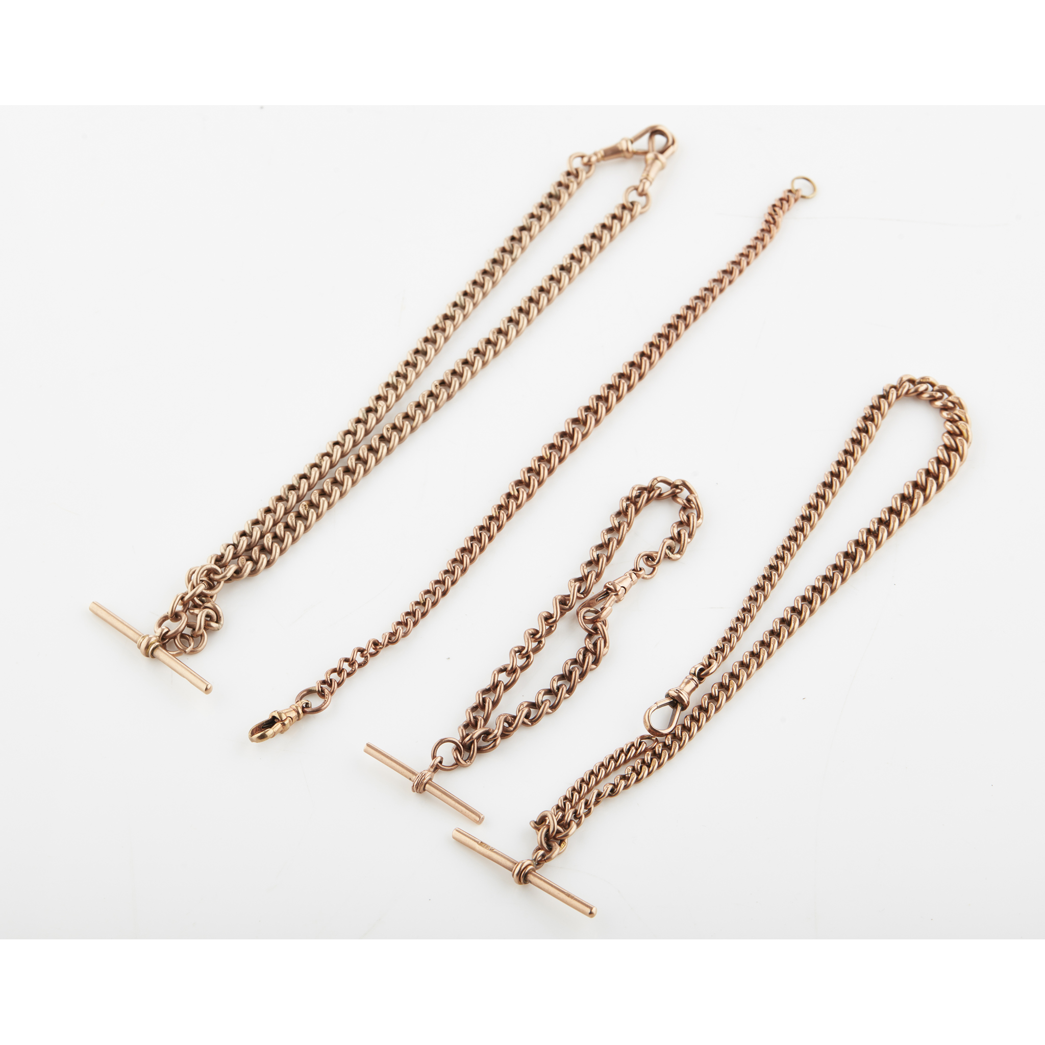 A group of four 9ct gold Alberts