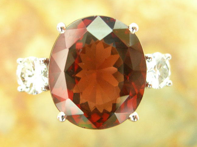 An 18ct white gold mounted garnet and diamond set ring,