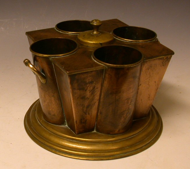 A pair of copper and brass bottle holders