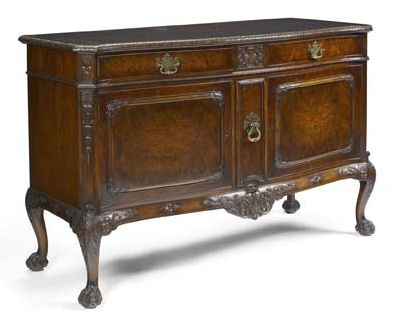 An early 20th century walnut serpentine sideboard By Waring and Gillow, in the George I style