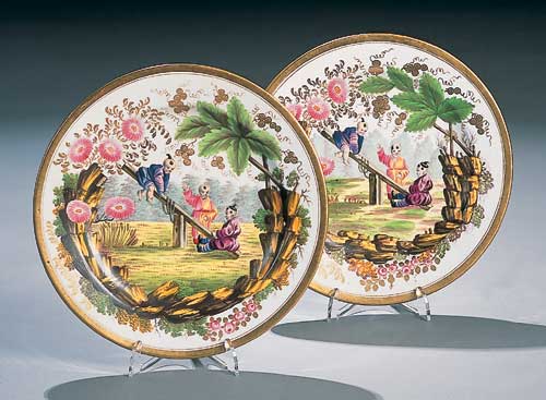 A pair of Minton circular white and gilt plates