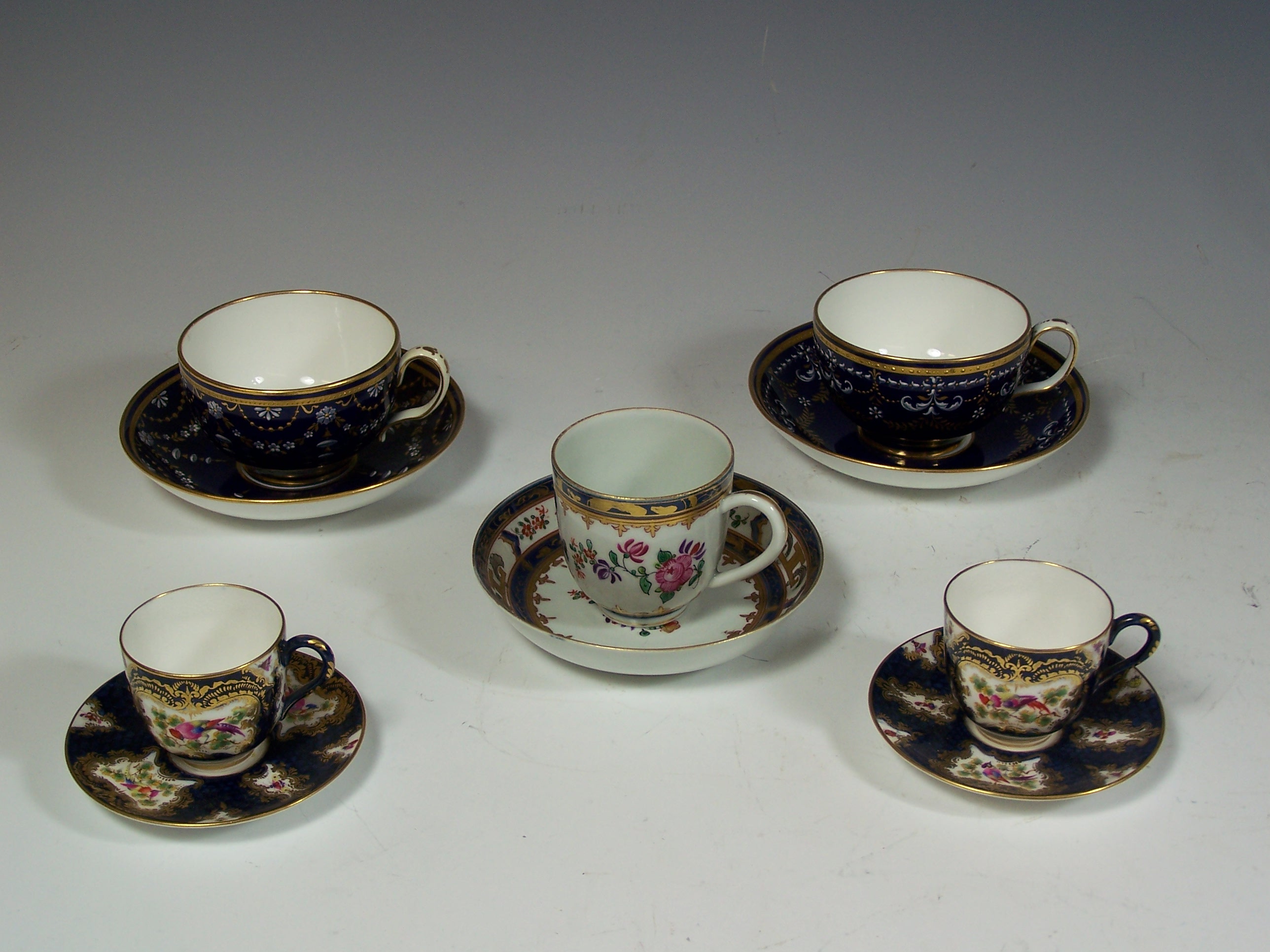 A pair of Minton tea cups and saucers