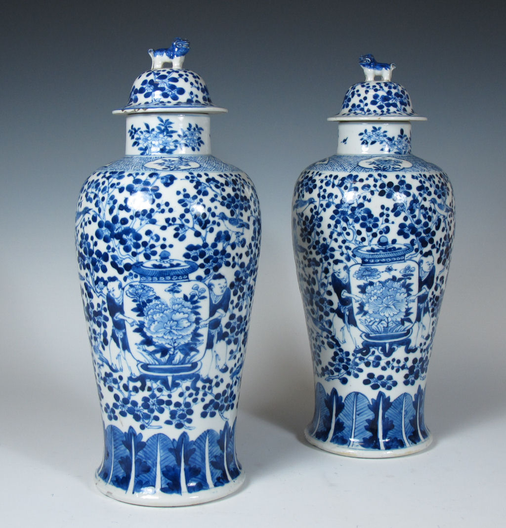 A pair of Chinese blue painted vases and covers