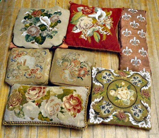 A collection of early 20th century and later beadwork and woolwork cushions