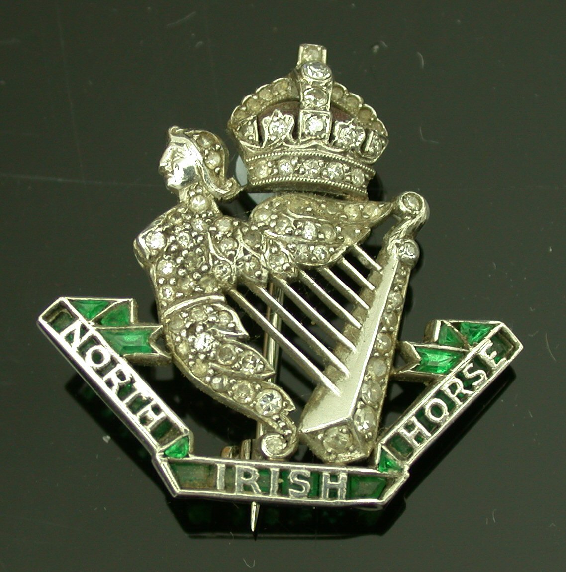 North Irish Horse - an early 20th century emerald and diamond regimental brooch,