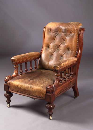A late Victorian walnut gentleman's library armchair
