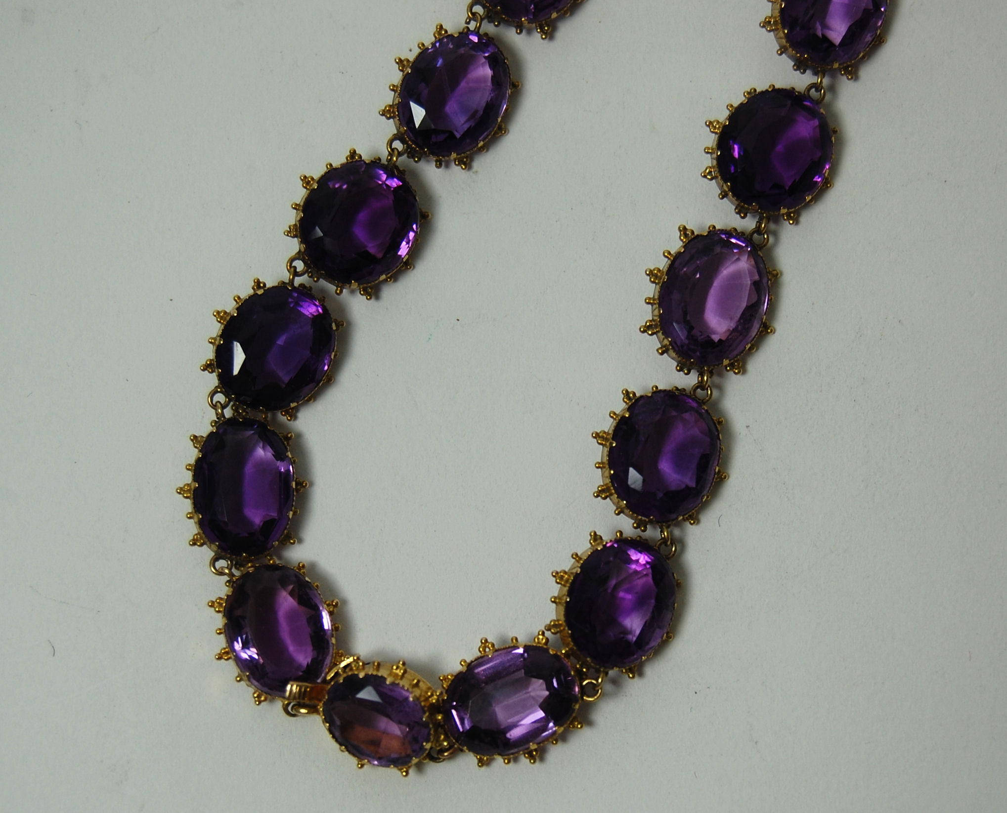 A Victorian gold mounted amethyst riviere necklace,