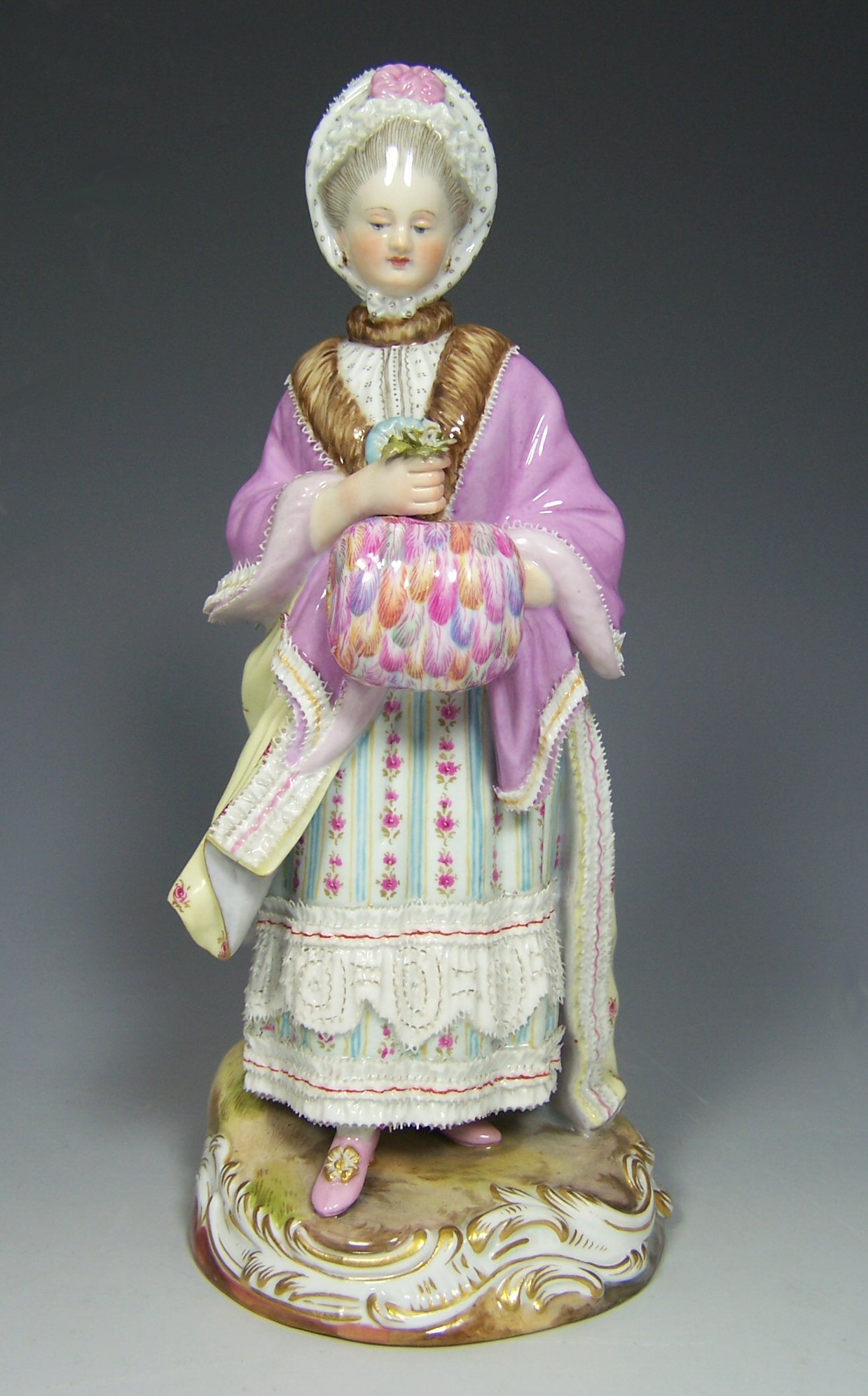 A 19th century Meissen figure of a girl with muff