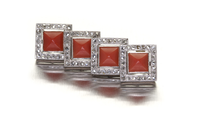 A pair of 14ct white gold diamond and coral set cufflinks