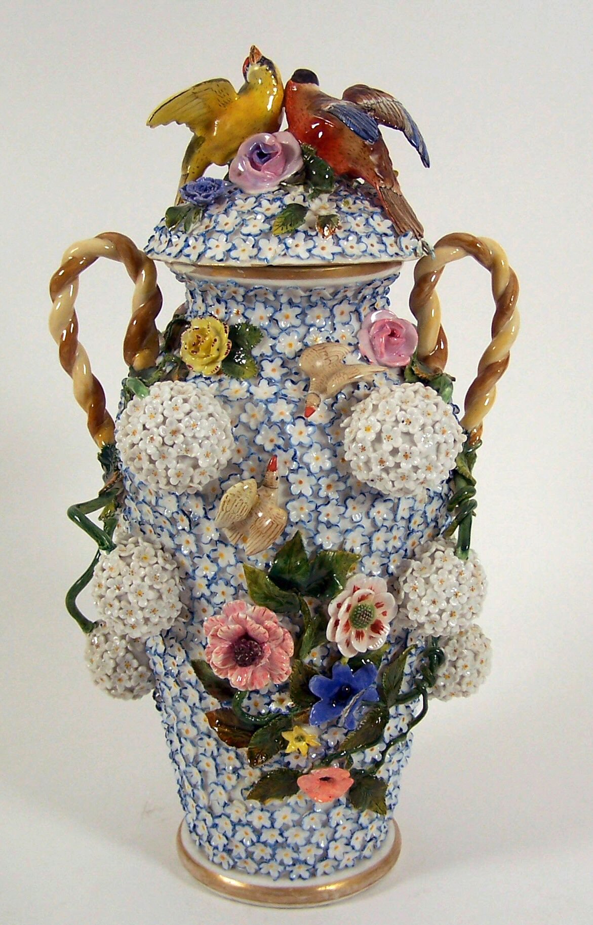 A late 19th/early 20th century Meissen style schneeballen baluster shaped vase and cover,