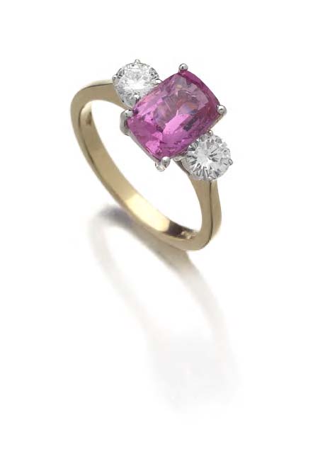 An 18ct gold mounted pink sapphire and diamond three-stone ring,
