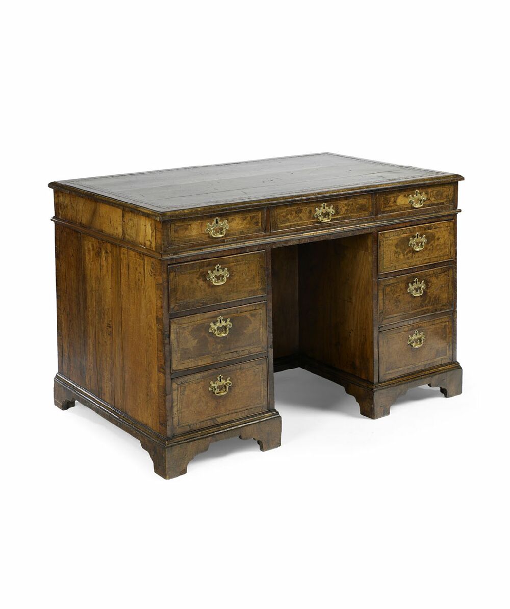 A George I period walnut and feather banded knee-hole desk