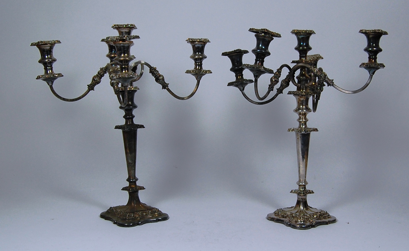 A pair of silver plated five light candelabra