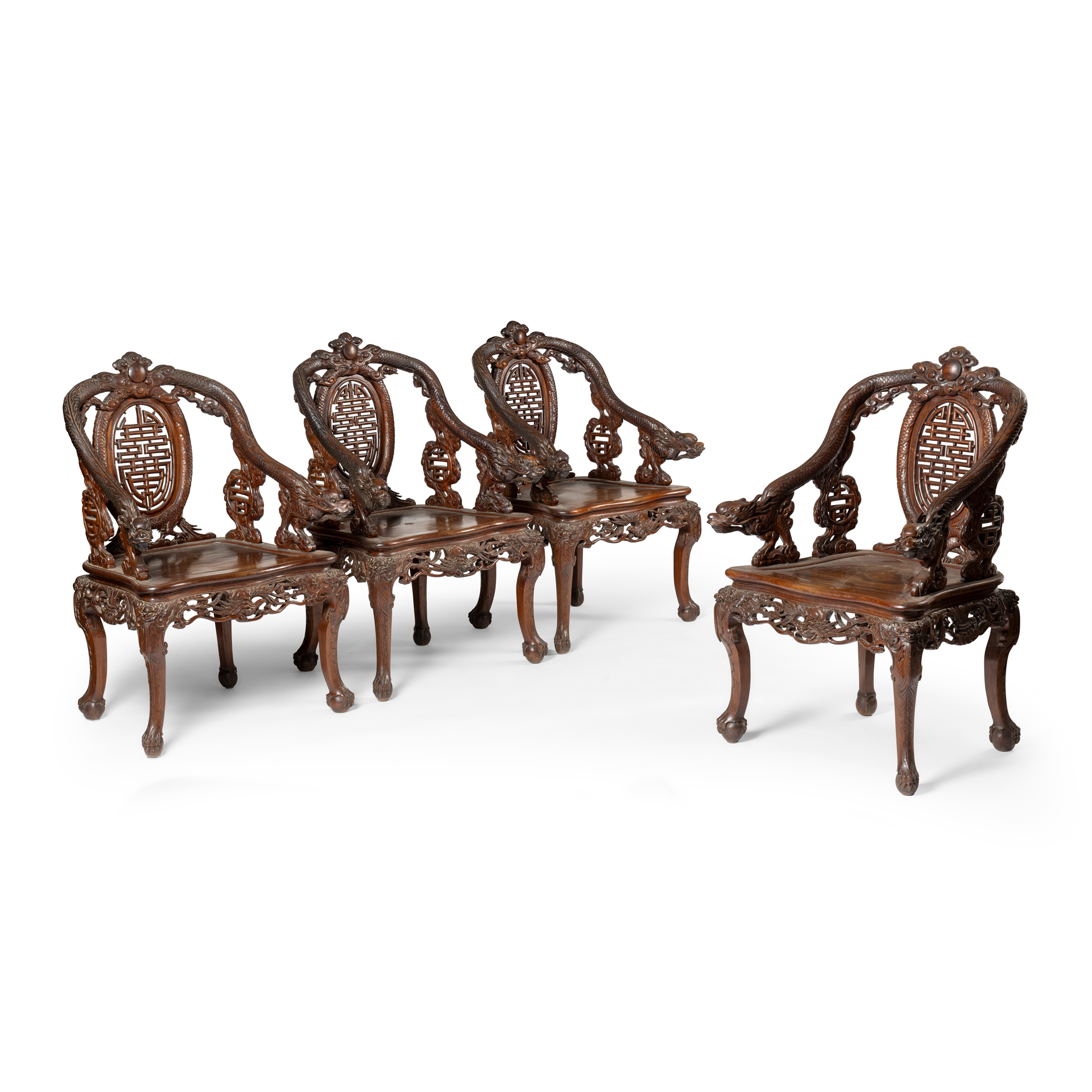 A SET OF FOUR CHINESE CARVED HARDWOOD ARMCHAIRS