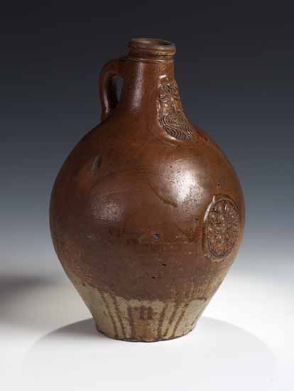 A 19th century German salt glazed bellied bellarmine jug