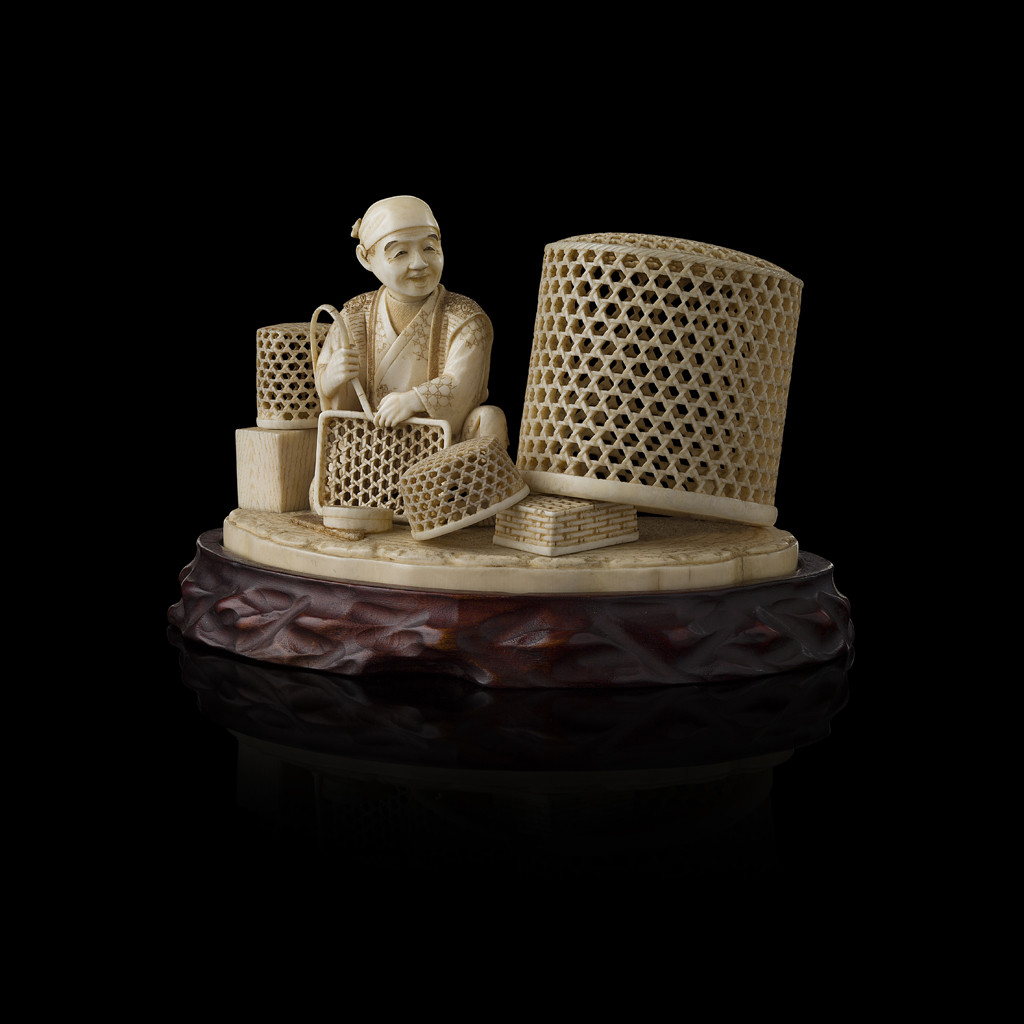 FINELY CARVED IVORY OKIMONO OF A BASKET MAKER