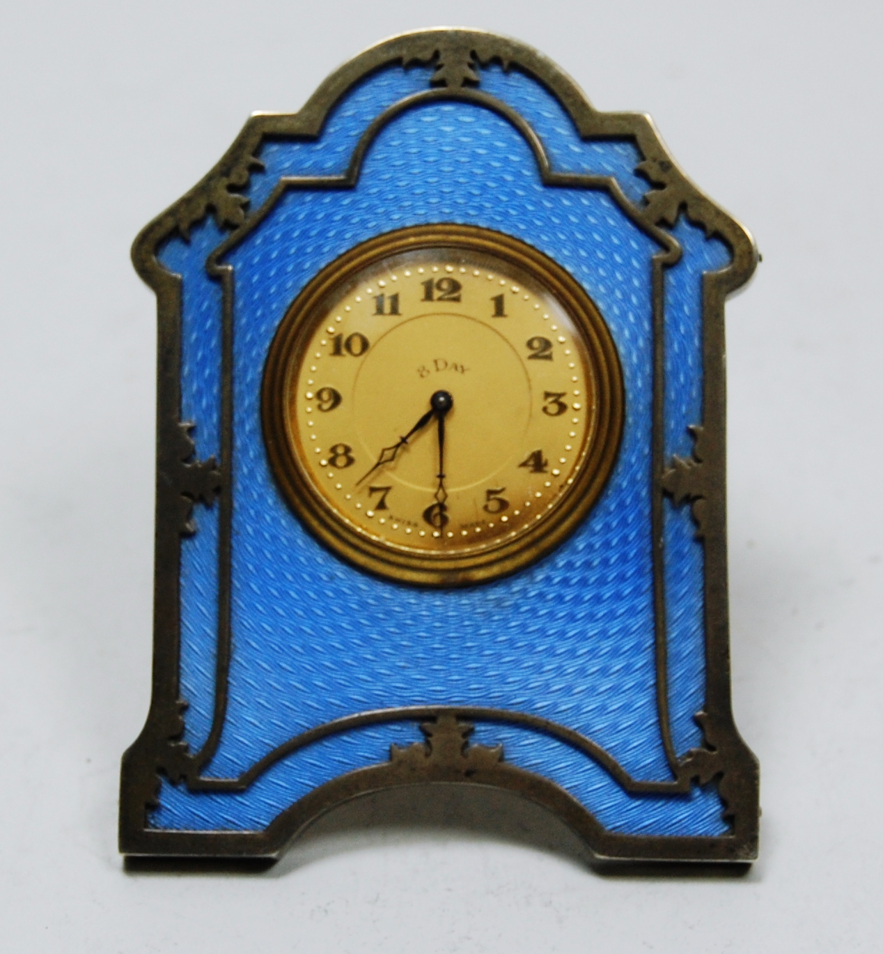 An enamel dressing table clock