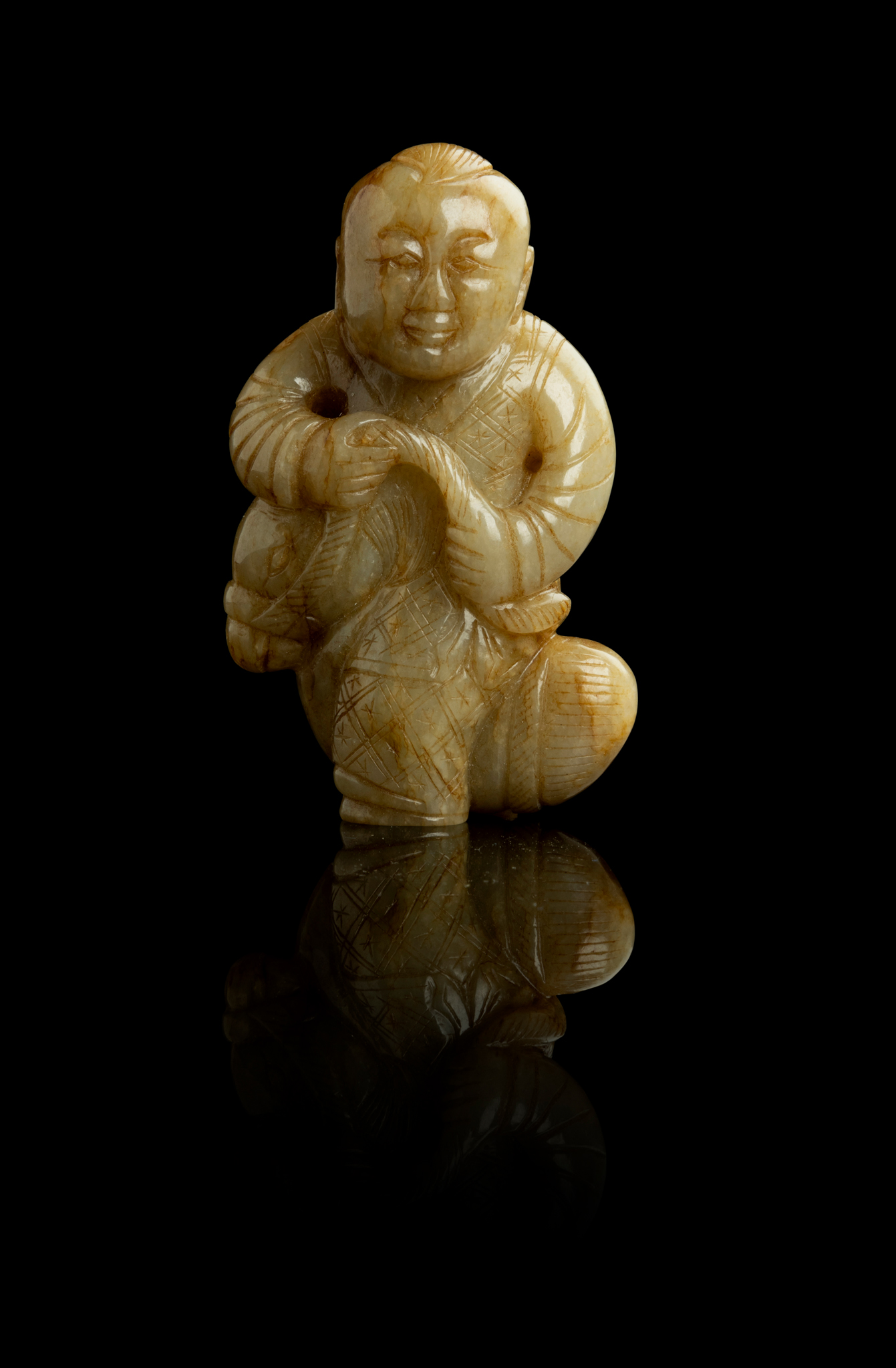 CELADON JADE WITH RUSSET INCLUSION CARVING OF A BOY RIDING PONY