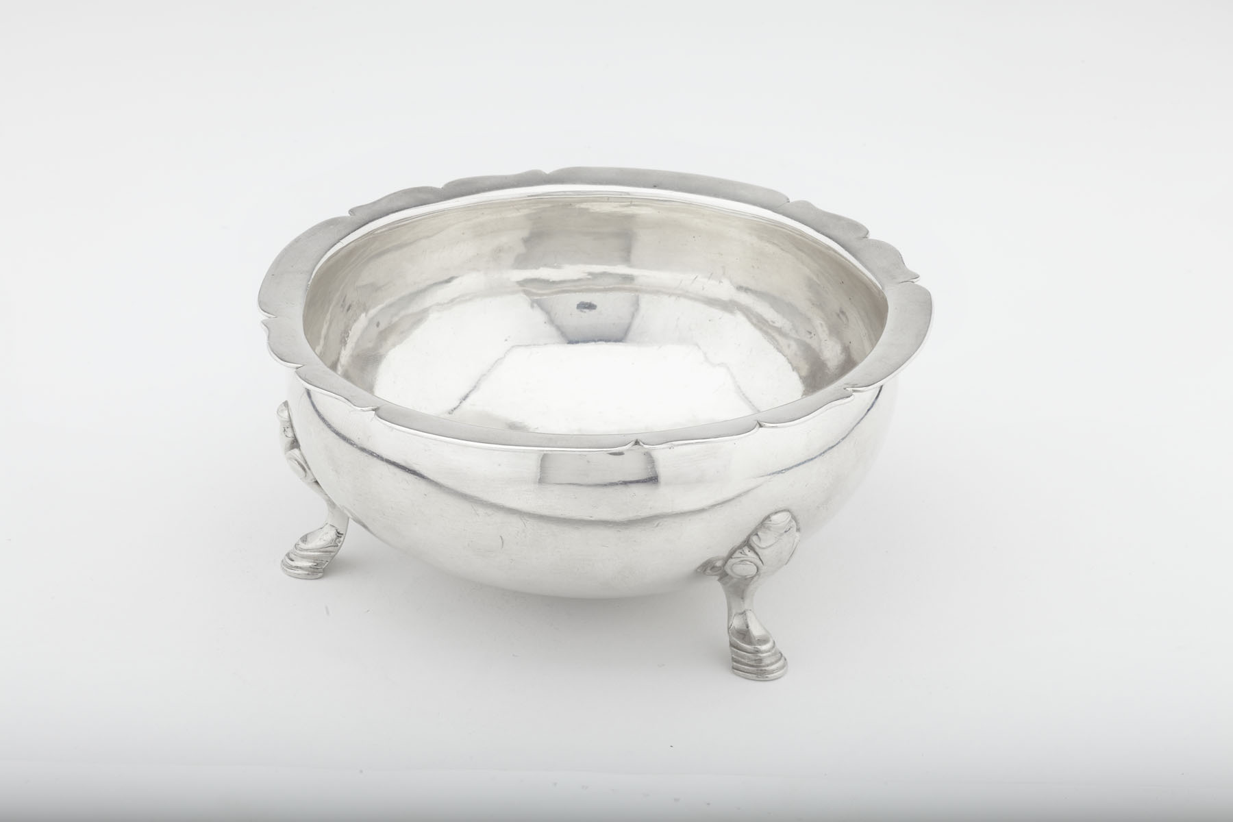 A rare George II three footed sugar / slop bowl