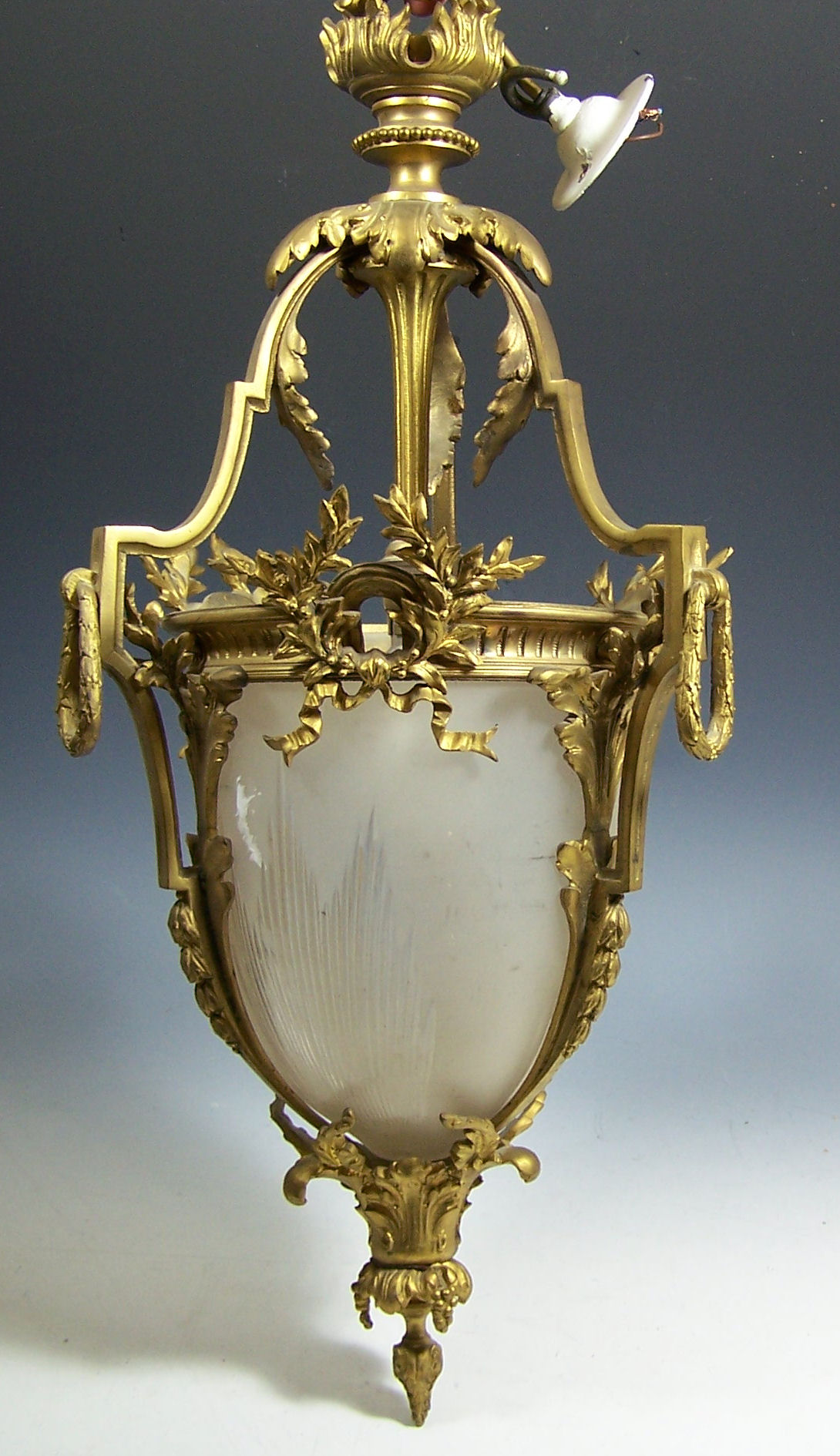 A matched pair of Edwardian gilt brass hanging lanterns,