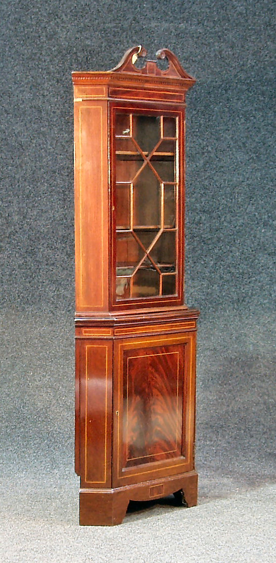 An Edwardian mahogany corner cabinet,