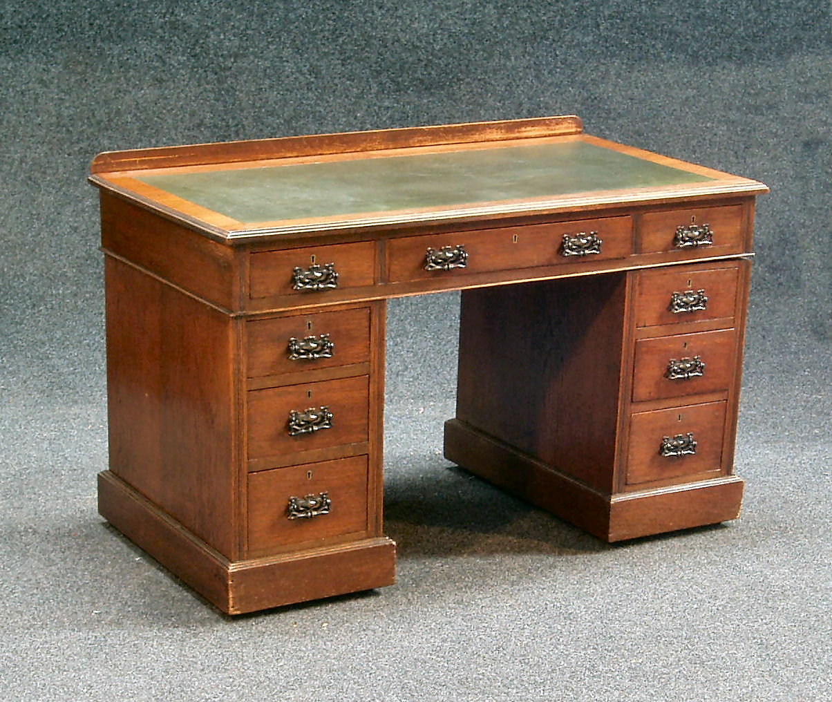 An Edwardian oak twin pedestal desk,