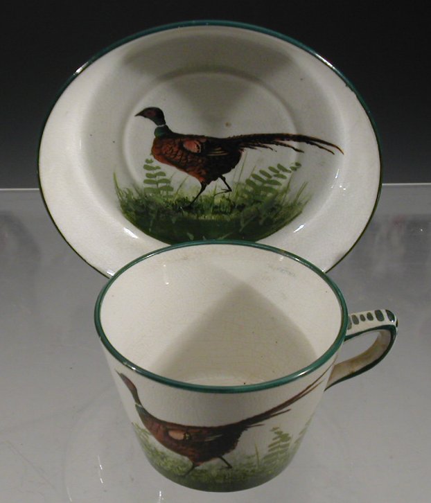 A Wemyss 'Pheasant' cup and saucer