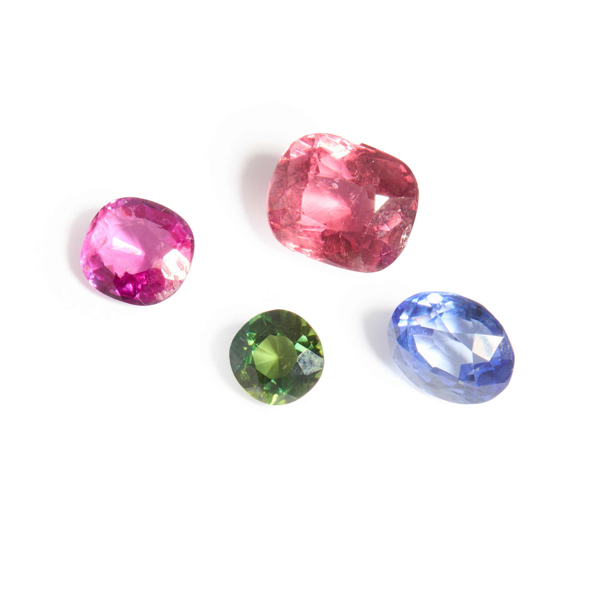 A collection of four unmounted gemstones