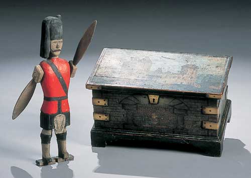 A naive painted wood whirly gig in the form of a kilted soldier