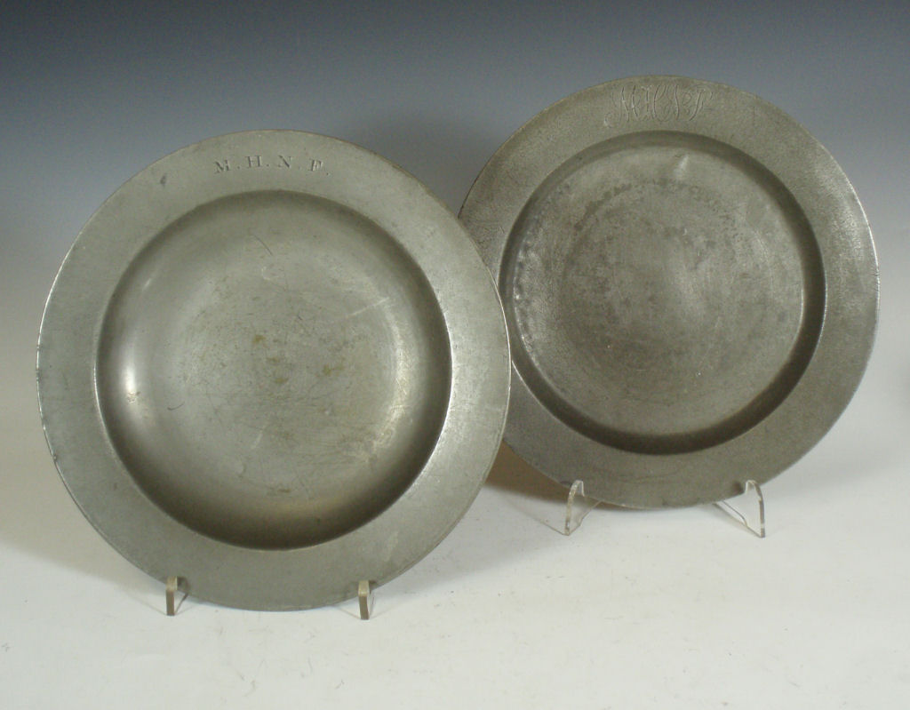 A group of five pewter plates