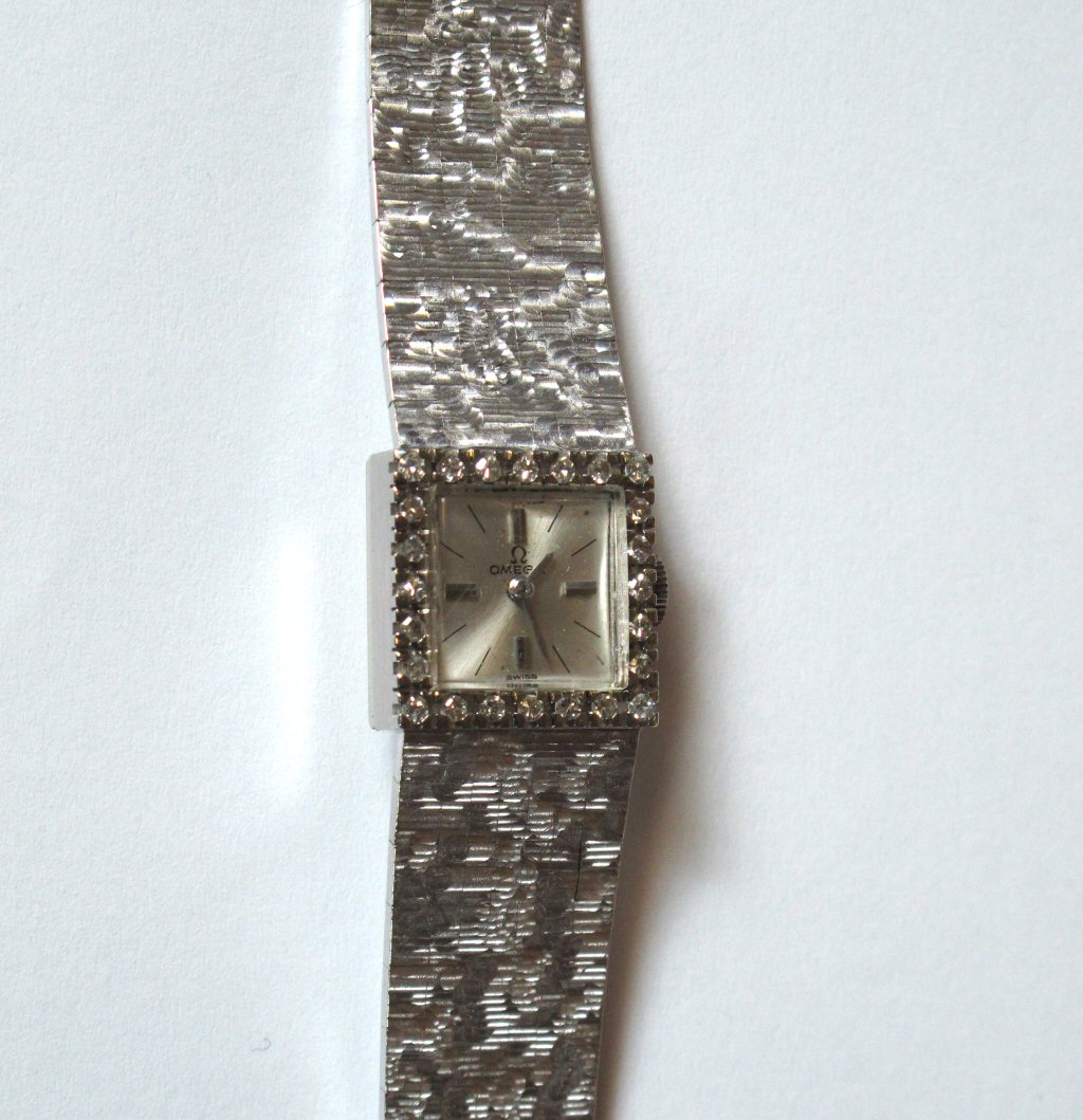 OMEGA - a lady's 18ct white gold diamond set wrist watch,